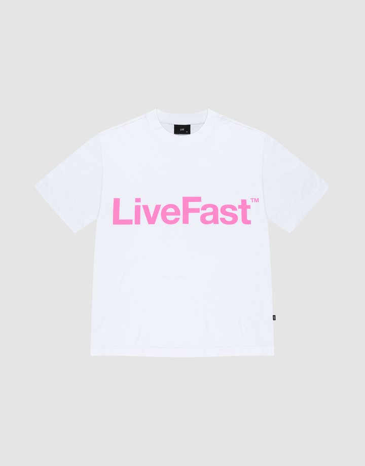 The Basic OS Livefast Tee by LIVE FAST DIE YOUNG features an oversize fit and a bold pink LiveFast™ frontprint on plain white, showcased laid flat against a light gray background. | plain