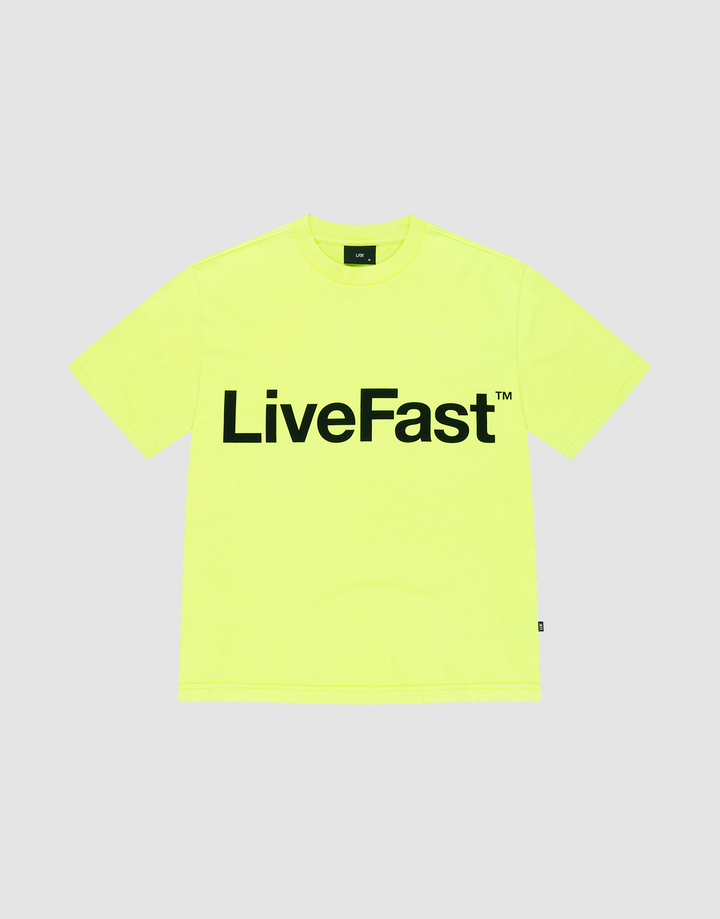 The Basic OS Livefast Tee by LIVE FAST DIE YOUNG is a bright yellow-green, 100% cotton oversize T-shirt featuring a bold black LiveFast™ chest print, shown on a plain light gray background. | plain