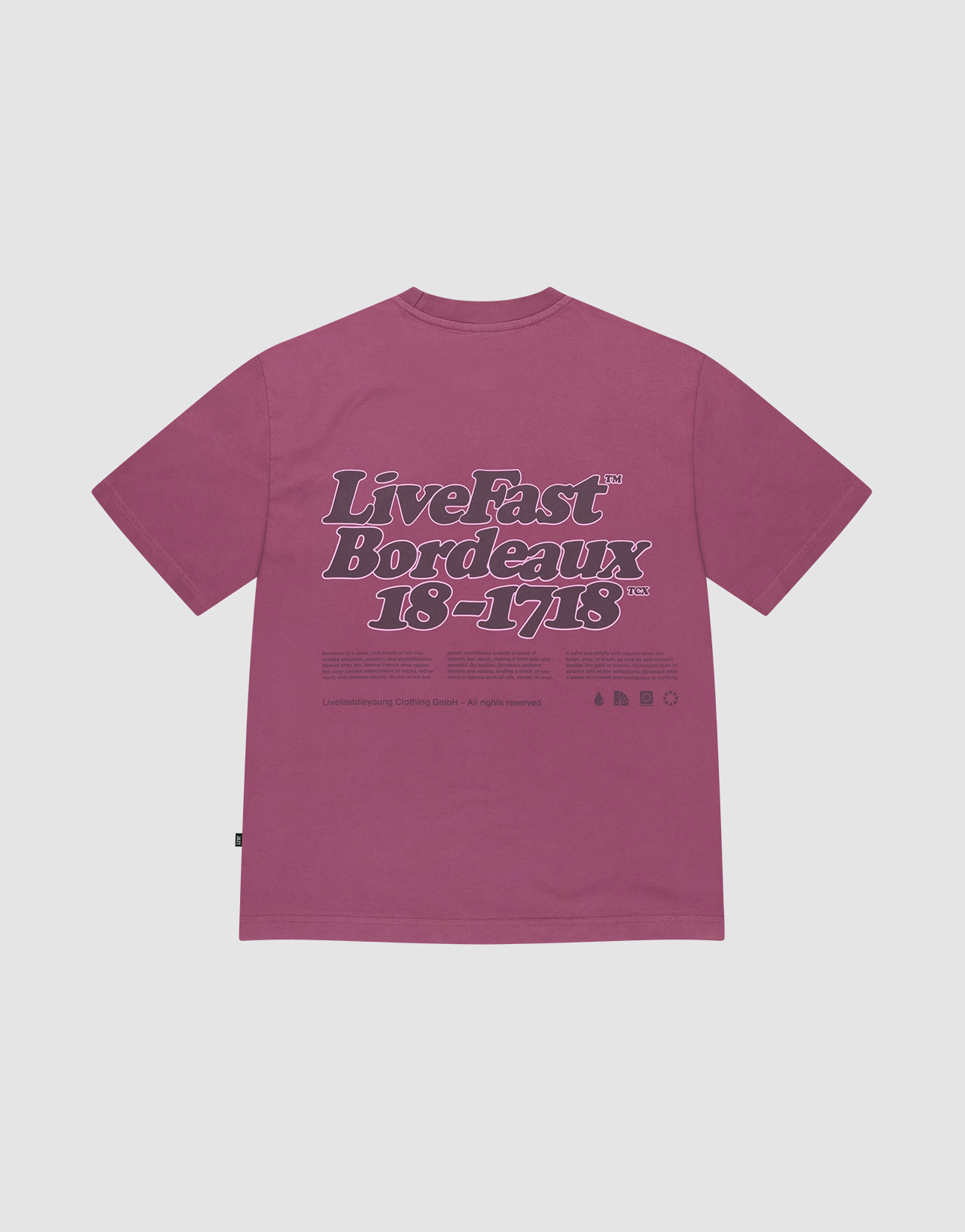 The LIVE FAST DIE YOUNG Basic 210 Tee in magenta is crafted from 100% Baumwolle. It features bold 'Live Fast Bordeaux 18–1718' text in dark purple and white with smaller details on the front and back, shown flat on a white background.