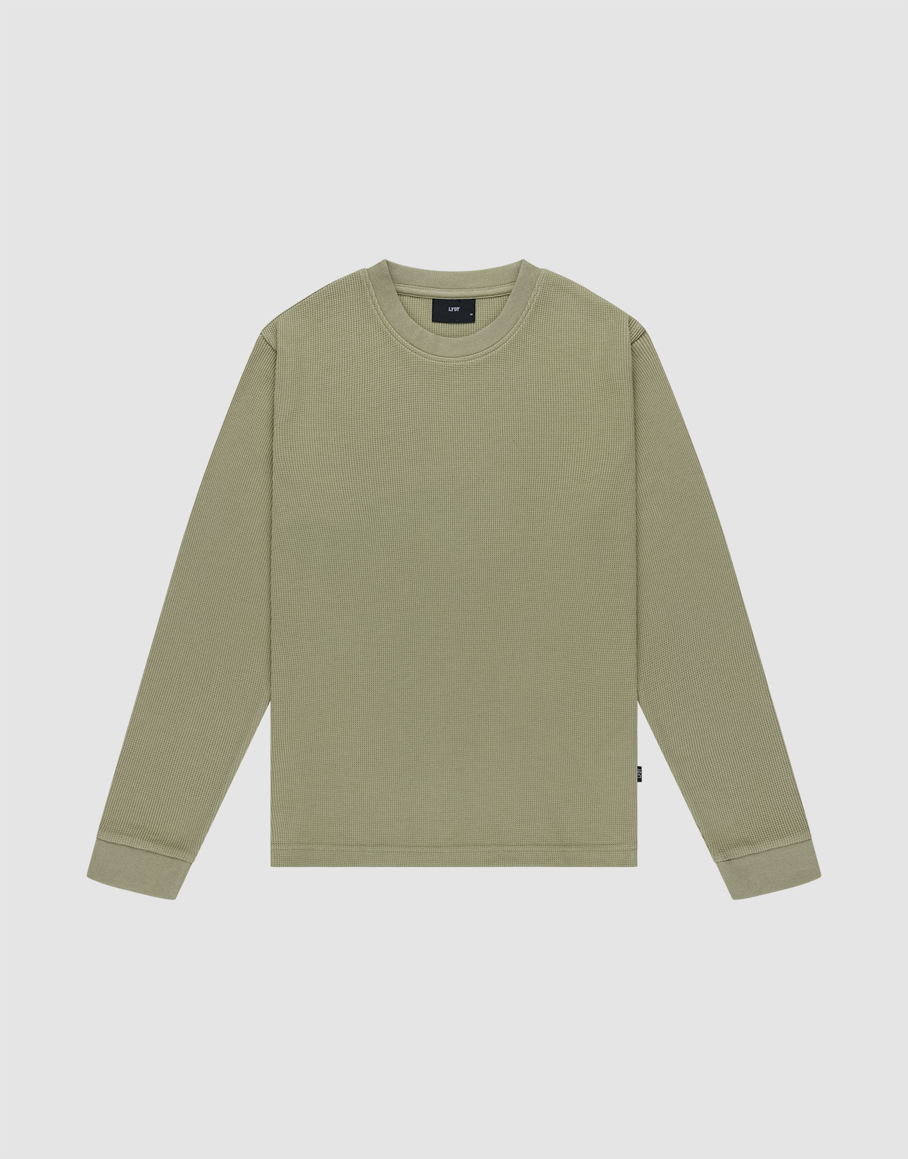 The Basic Waffle Longsleeve by LIVE FAST DIE YOUNG is a plain, light olive green, crew neck shirt with long sleeves made from soft Baumwolle, shown flat on a light gray background.