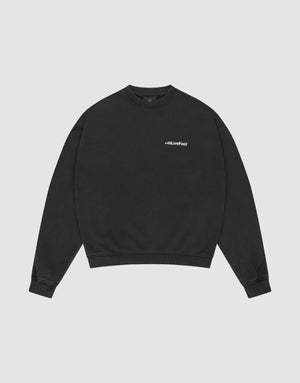 The LIVE FAST DIE YOUNG Basic +49 Chest Sweater is a black, oversized crewneck with ribbed cuffs and a small white #LLJLiveFast chest print, made from a cotton-polyester blend, shown flat on a light gray background. | plain
