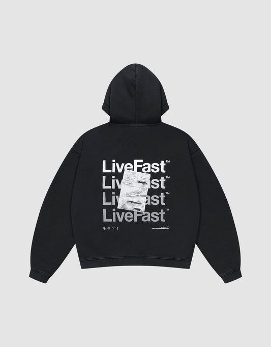 The LIVE FAST DIE YOUNG Basic Evidence Hooded Zip is a black oversized hoodie with repeated white "LiveFast™" and LFDY branding on the back, layered with a printed receipt graphic. Features a zip front and classic hood up style. | plain