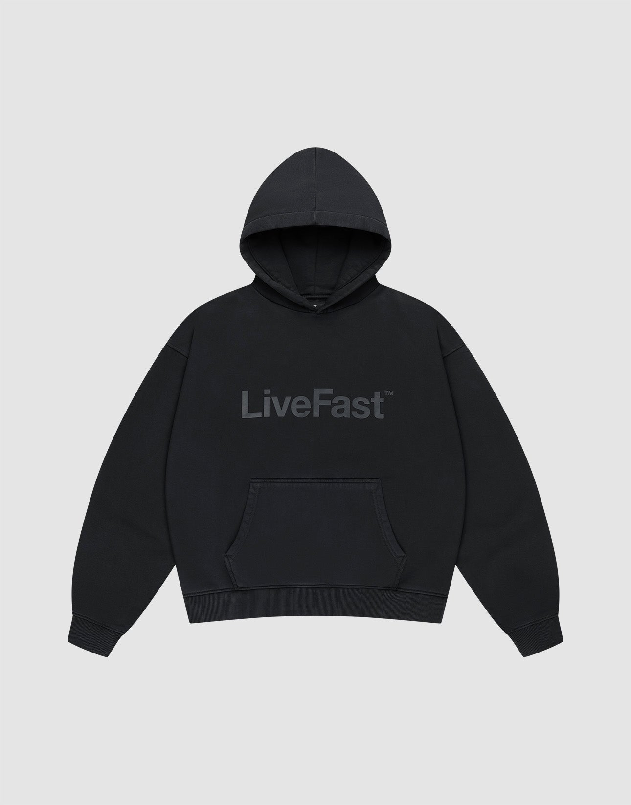 The Basic Livefast Hooded by LIVE FAST DIE YOUNG is an oversized black hoodie featuring a subtle "LiveFast" front print, crafted from soft cotton and shown against a plain light gray background.