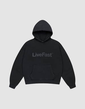 The Basic Livefast Hooded by LIVE FAST DIE YOUNG is an oversized black hoodie featuring a subtle "LiveFast" front print, crafted from soft cotton and shown against a plain light gray background. | plain