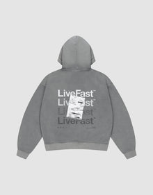 The Basic Evidence Hooded by LIVE FAST DIE YOUNG features an oversize fit, faded gray fabric, and bold “Live Fast” prints in white and gray on the back, with a shipping label graphic. The background is plain light gray. | plain