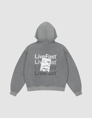 The Basic Evidence Hooded by LIVE FAST DIE YOUNG features an oversize fit, faded gray fabric, and bold “Live Fast” prints in white and gray on the back, with a shipping label graphic. The background is plain light gray. | plain
