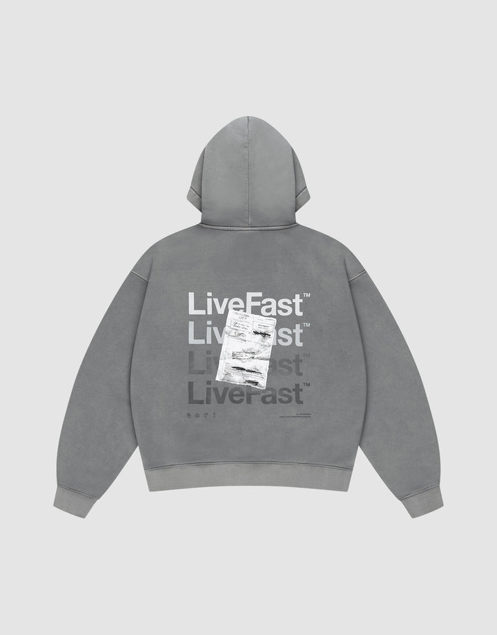The Basic Evidence Hooded by LIVE FAST DIE YOUNG features an oversize fit, faded gray fabric, and bold “Live Fast” prints in white and gray on the back, with a shipping label graphic. The background is plain light gray. | plain