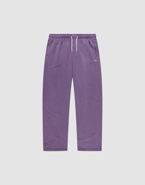 The Basic Wide Jogger by LIVE FAST DIE YOUNG features a purple color, elastic waistband, white drawstring, side pockets, and a relaxed wide fit. Shown laid flat on a plain light grey background. | plain