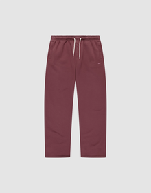 The Basic Wide Jogger by LIVE FAST DIE YOUNG features a burgundy color, elastic waistband, white drawstring, side pockets, and a small white LIVI logo-print on the left hip. The wide fit pants are shown laid flat on a light background. | plain