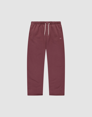 The Basic Wide Jogger by LIVE FAST DIE YOUNG features a burgundy color, elastic waistband, white drawstring, side pockets, and a small white LIVI logo-print on the left hip. The wide fit pants are shown laid flat on a light background. | plain