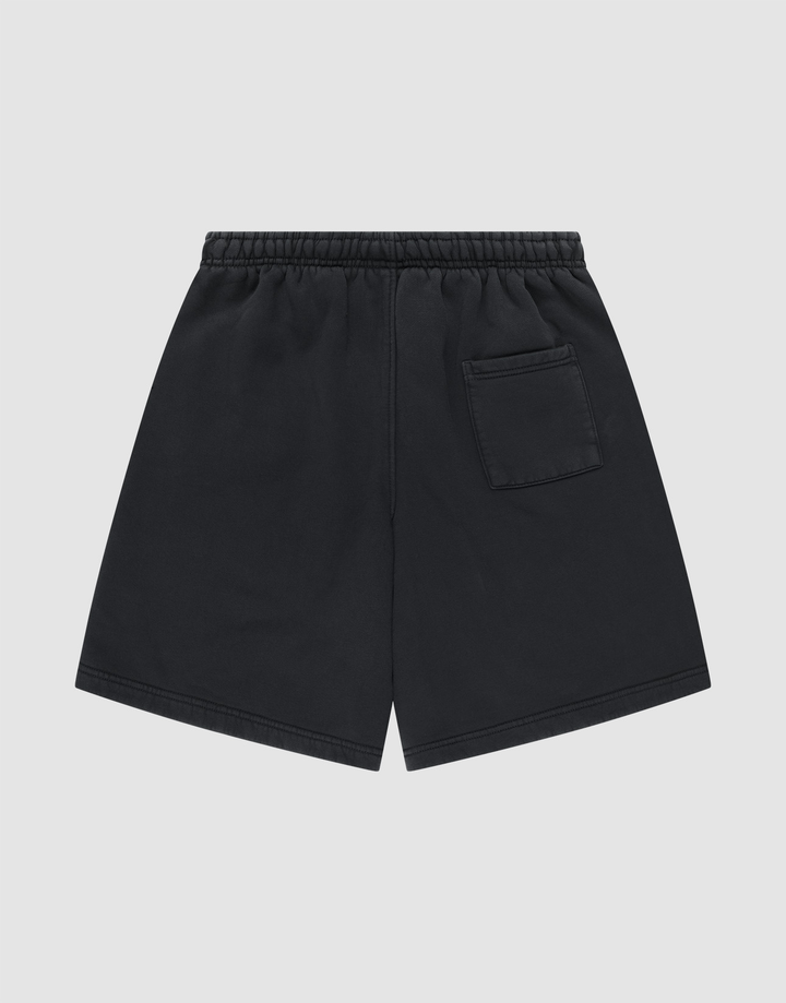 LIVE FAST DIE YOUNG Basic Shorts in black, featuring an elastic waistband and a small patch pocket on the back right. Displayed flat on a light gray background. Regular Fit design for everyday comfort.