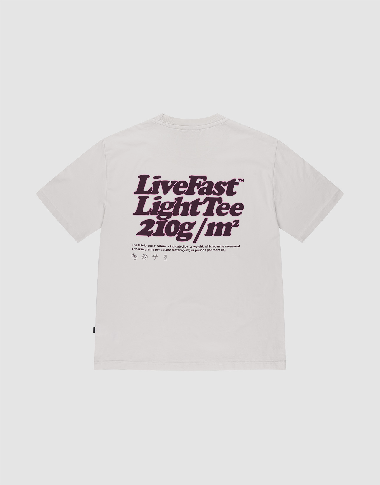 The LIVE FAST DIE YOUNG Basic 210 Tee is an oversized white T-shirt made from 100% cotton, featuring a bold “LiveFast” print on the back, front and back prints with text and symbols beneath, and a weight of 210g/m². | plain