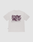 The LIVE FAST DIE YOUNG Basic 210 Tee is an oversized white T-shirt made from 100% cotton, featuring a bold “LiveFast” print on the back, front and back prints with text and symbols beneath, and a weight of 210g/m².
