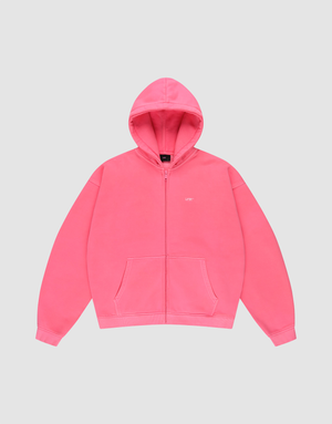 The LIVE FAST DIE YOUNG "Basic Hooded Zip" is a bright pink, oversize-fit zip-up hoodie with front pockets, a hood, and subtle white branding on the left chest, shown against a plain light gray background. | plain