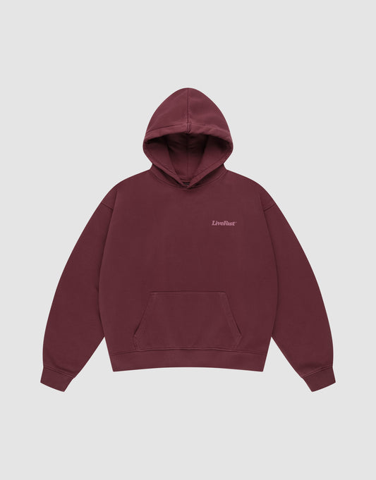 The Basic 360 Hooded by LIVE FAST DIE YOUNG is a maroon cotton hoodie with a front pocket, small "LiveFast" text on the left chest, and an oversize fit, shown against a plain light gray background.