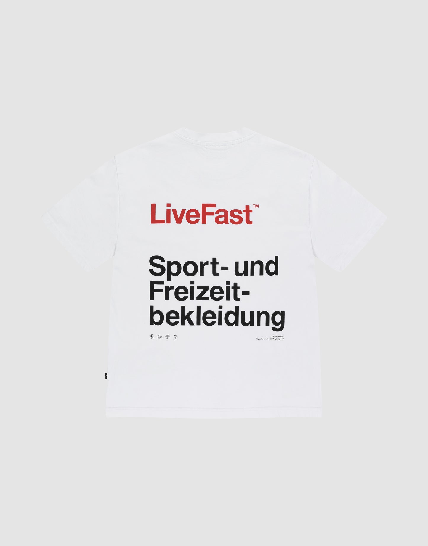 The Basic Trademark Tee by LIVE FAST DIE YOUNG is a white Oversize Fit shirt made from 100% cotton, with a bold red "LiveFast" front print and "Sport- und Freizeitbekleidung" back print, shown on a plain light gray background.