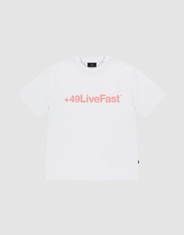 The Basic +49 Tee by LIVE FAST DIE YOUNG is an oversized white t-shirt made from 100% Baumwolle, featuring a bold pink +49LiveFast™ front print, displayed on a plain light gray background. | plain