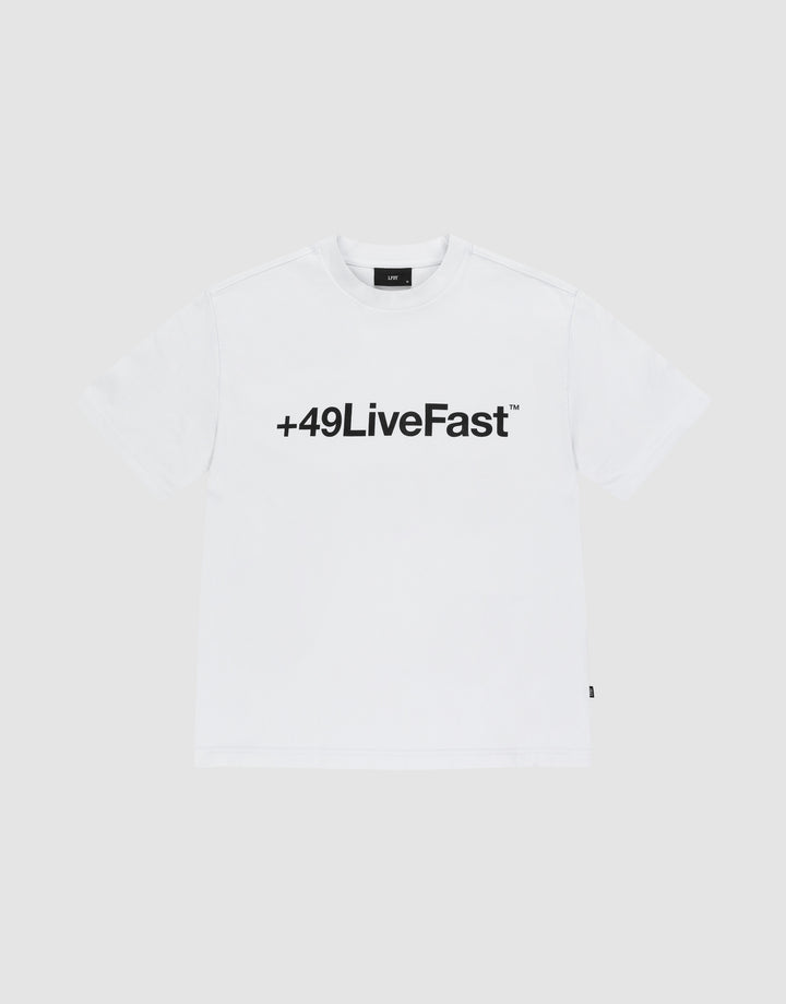 The Basic +49 Tee by LIVE FAST DIE YOUNG features a bold black “+49LiveFast™” front print on white, made from 100% Baumwolle, shown against a plain light grey background. | plain