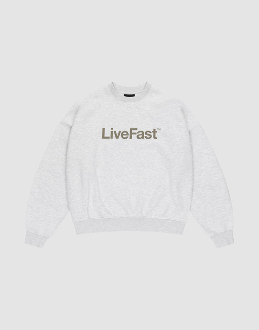 The Basic LiveFast Sweater by LIVE FAST DIE YOUNG is a light gray crewneck with an oversized fit and bold, dark LiveFast™ print on the chest, shown flat on a plain white background. | plain