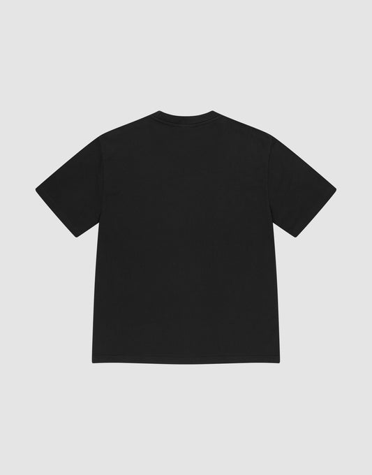The LIVE FAST DIE YOUNG Basic Heavy Tee, an oversized black short-sleeve t-shirt made from 100% Baumwolle, is shown laid flat with the back facing up on a light gray background, featuring a subtle Flag-Label detail.