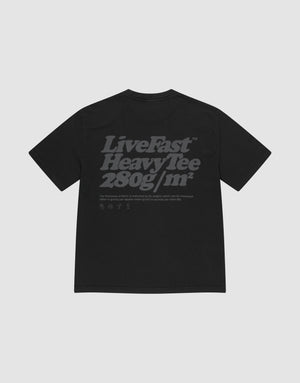 The Basic 280 Tee by LIVE FAST DIE YOUNG is a black oversized t-shirt made from 100% cotton, featuring bold gray "Live Fast Heavy Tee 280g/m²" backprint with smaller text/icons, plus prints on both sides. Shown on a light gray background. | plain