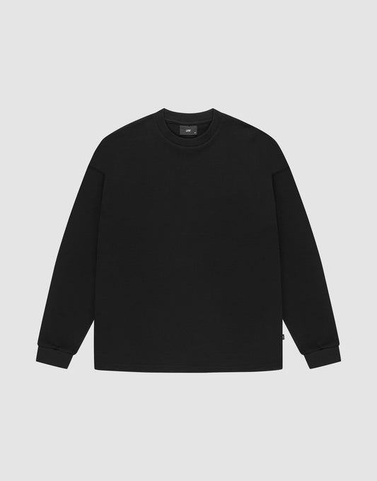 The LIVE FAST DIE YOUNG Blank Waffle Longsleeve, a black oversized crewneck sweatshirt made from 100% Baumwolle, features Ripp-Bündchen at the cuffs and neckline and is shown laid flat on a light gray background. | plain