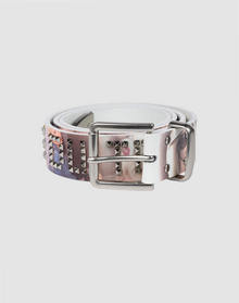 The LFDY Iconic Belt by LIVE FAST DIE YOUNG is a white leather belt with metal pyramid studs, a silver buckle, and a printed graphic design on the strap, shown coiled on a plain light background. | plain