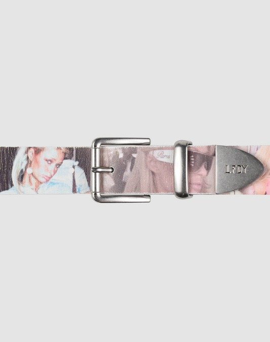 The LFDY Iconic Belt by LIVE FAST DIE YOUNG features printed leather with faded women’s images, a metal buckle, and an LFDY-engraved tip. The light gray background highlights this accessory's unique style. | model