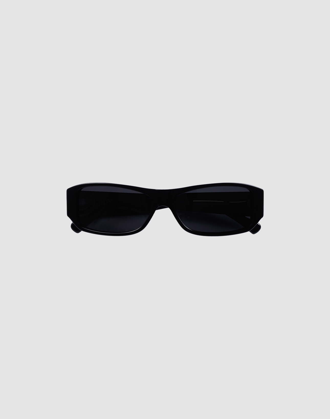 The LFDY Wrap by LIVE FAST DIE YOUNG is a pair of rectangular black sunglasses with dark lenses and UV-Schutz, displayed on a plain light gray background.