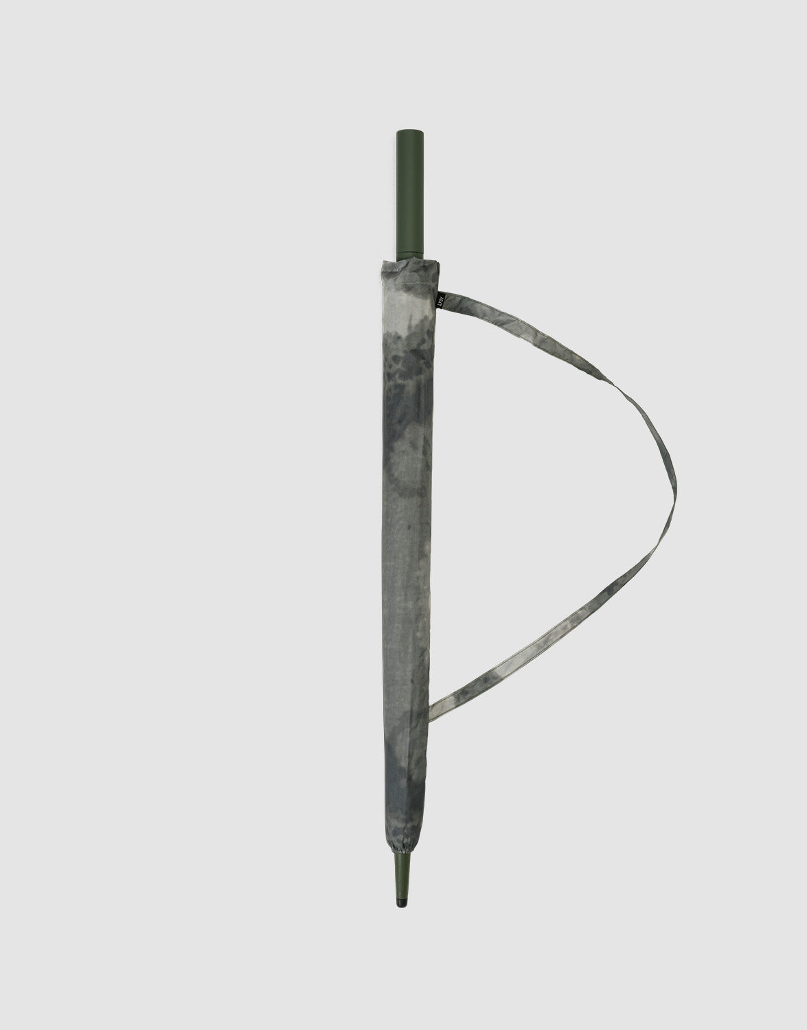A closed LFDY Umbrella by LIVE FAST DIE YOUNG with a green handle and tip, wrapped in a gray tie-dye case with Metallstreben for stability and a matching strap, displayed on a plain light gray background.