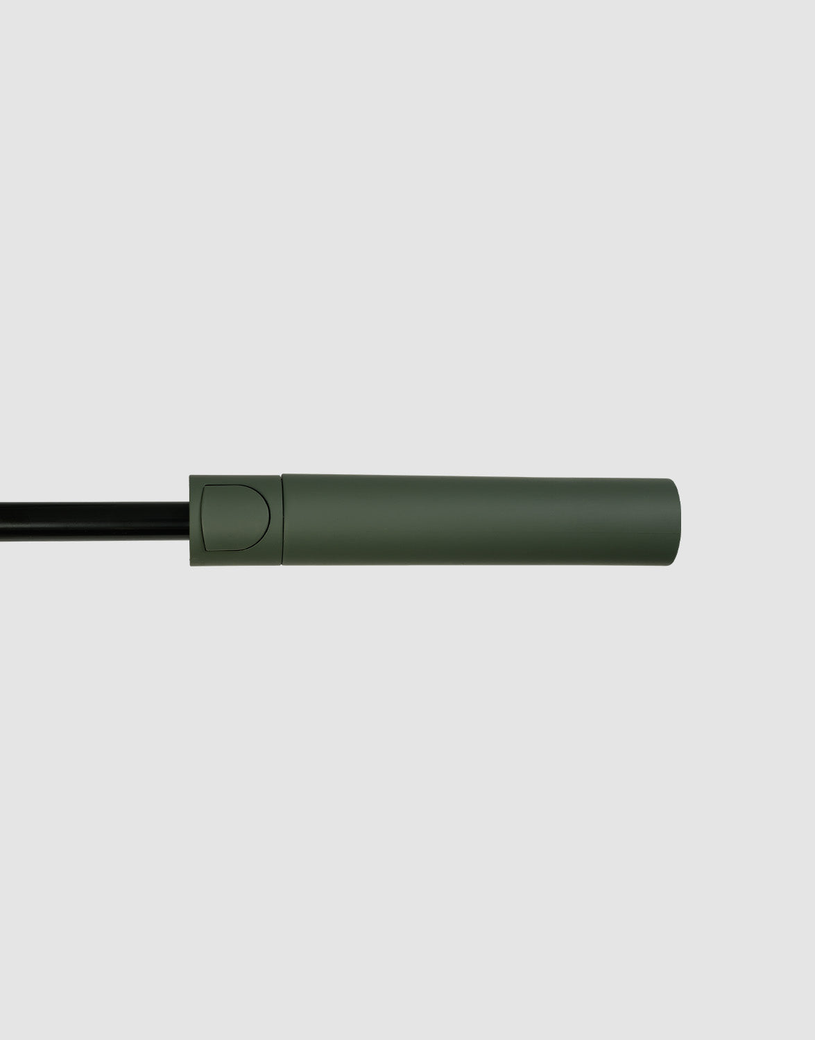 The LFDY Umbrella by LIVE FAST DIE YOUNG features a matte green cylindrical handle with a rounded end, attached to a black frame, displayed against a plain light gray background.
