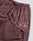 LIVE FAST DIE YOUNG Wide Cuff Jogger: maroon, wide fit, soft French Terry (100% Baumwolle), elastic waistband with drawstrings, side pockets, and "Live Fast" in white script on the upper thigh.