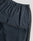 Close-up of the LFDY Striped Jogger by LIVE FAST DIE YOUNG in navy blue with elastic waistband, side zipper pocket, and dark gray side panels, laid flat on a light gray background.