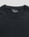 Close-up of a plain black LFDY Slim Tee by LIVE FAST DIE YOUNG, lying flat to reveal the upper chest and neckline. A black label with "LFDY" text is visible inside the collar. The shirt is crafted from soft cotton.