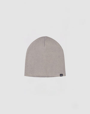 A light gray, ribbed knit Uncuffed Beanie from LFDY aus Baumwolle, featuring a small black logo patch on the lower edge, displayed on a plain white background.