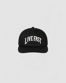 The Live Fast Unstructured Cap by LIVE FAST DIE YOUNG is a black baseball cap featuring a Flag Label and bold white LIVE FAST Logo-Stick embroidery on the front, shown against a plain light gray background.