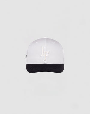 The LF Snapback by LIVE FAST DIE YOUNG features a white cap with a white LF logo, black brim with black underside, and snap closure, shown on a plain light gray background.