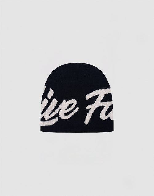 The LFDY Jacquard Beanie by LIVE FAST DIE YOUNG features bold white cursive branding on black Polyacryl knit, with the logo partially visible against a plain light gray background.