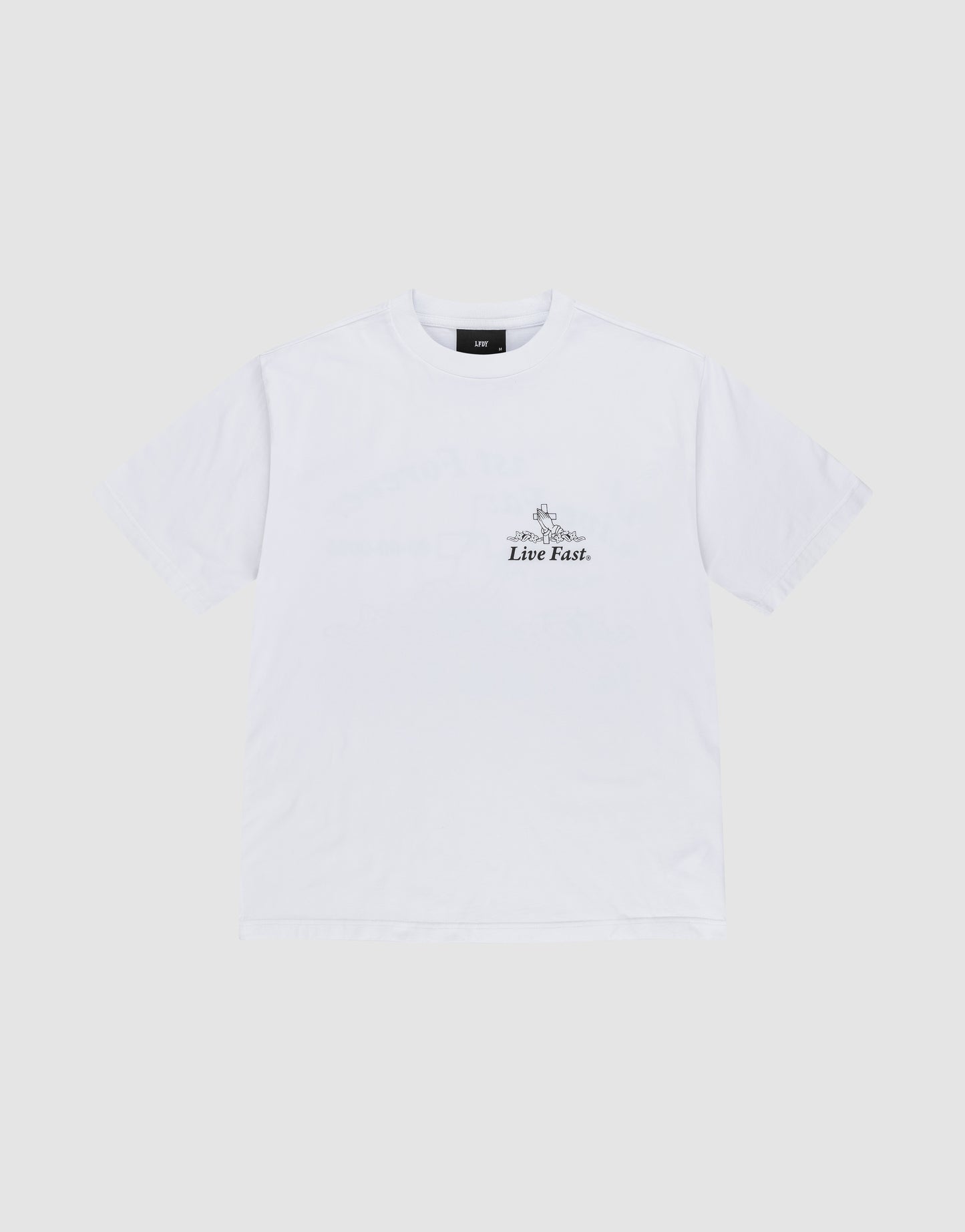 The LFDY Praying Tee by LIVE FAST DIE YOUNG is an Oversize Fit white short-sleeve t-shirt made from soft cotton, featuring "Live Fast." in small black text on the left chest, laid flat on a light gray background.