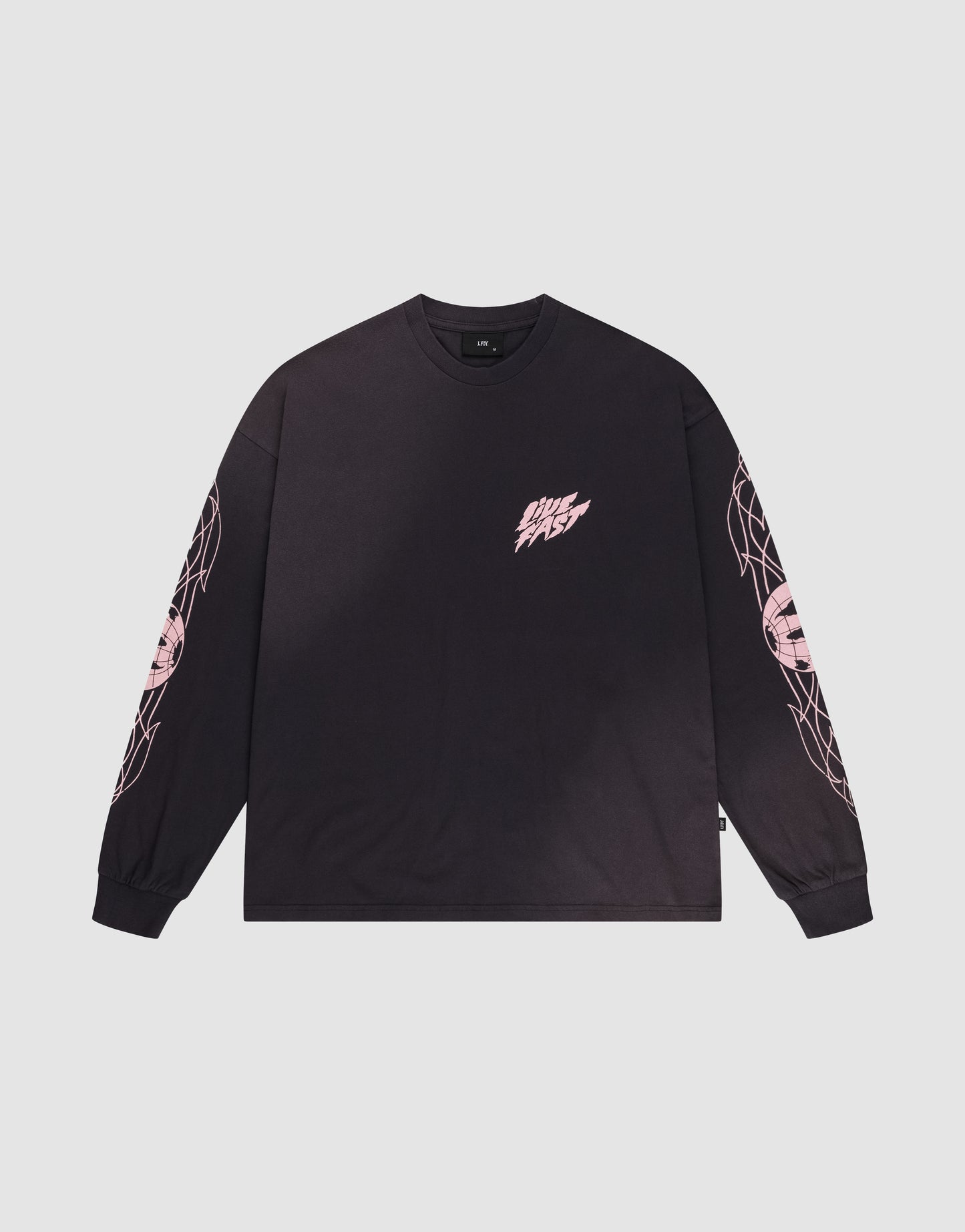 The LFDY Logo Longsleeve by LIVE FAST DIE YOUNG is a black, oversized tee with light pink graphics on both sleeves and a small pink DMS FAST logo on the left chest, shown laid flat on a white background.