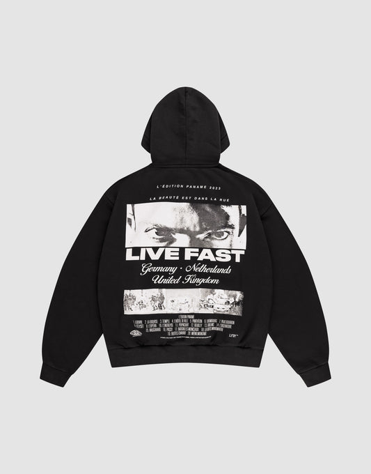 The LFDY Cinema Hooded by LIVE FAST DIE YOUNG is an oversized black cotton hoodie with intense eyes and "LIVE FAST" printed on the front, plus Germany, Netherlands, United Kingdom text and a cityscape image on the back. | plain