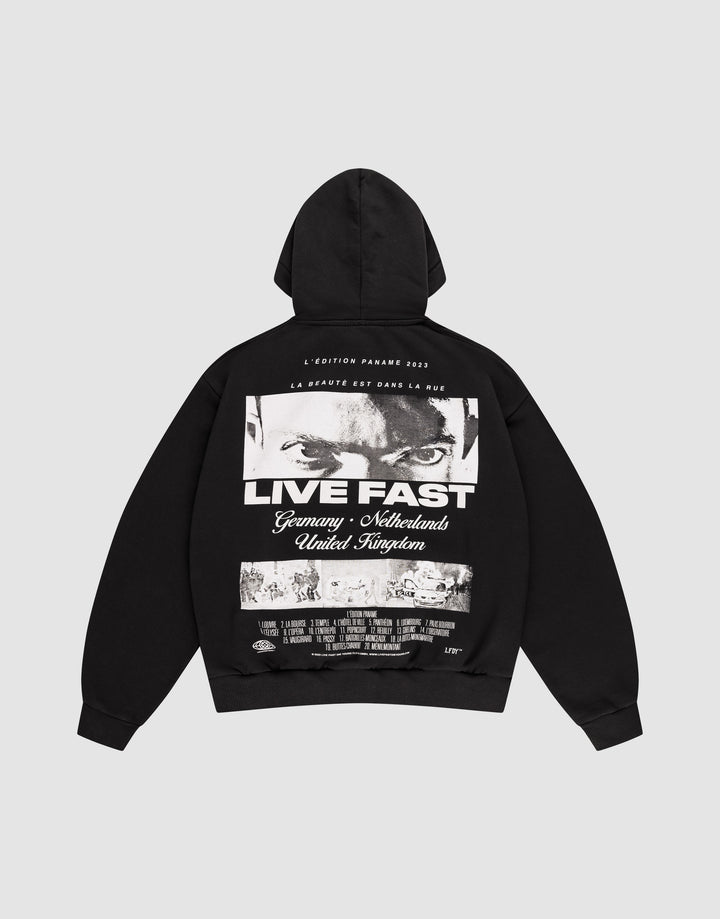 The LFDY Cinema Hooded by LIVE FAST DIE YOUNG is an oversized black cotton hoodie with intense eyes and "LIVE FAST" printed on the front, plus Germany, Netherlands, United Kingdom text and a cityscape image on the back. | plain
