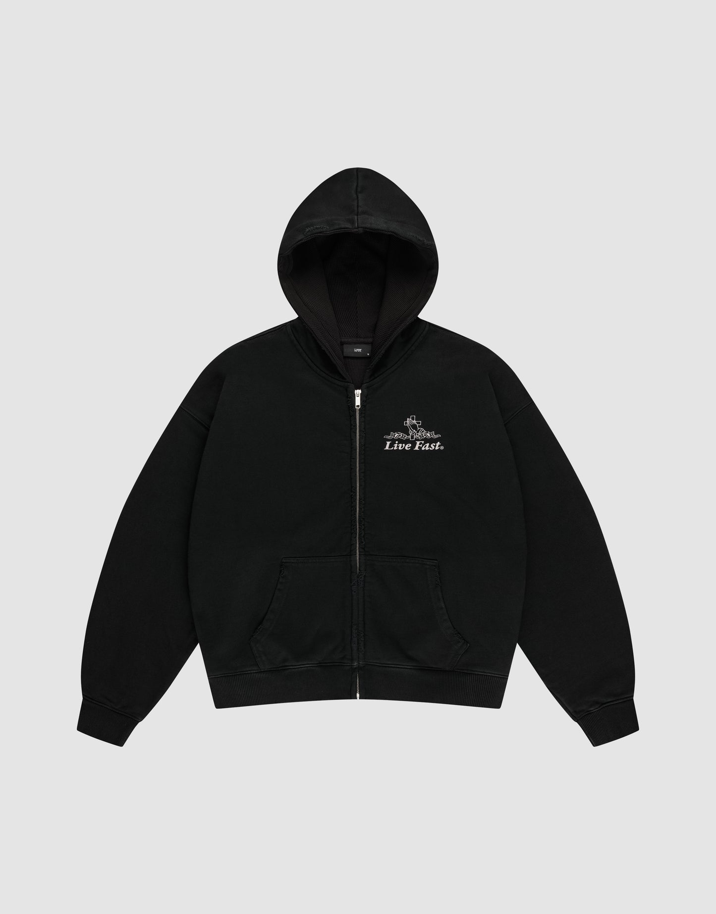 The LFDY Praying Hooded Zip by LIVE FAST DIE YOUNG is a black oversized zip-up hoodie with a front pocket and hood, featuring small white "Live Fast" text and graphic on the left chest. Light gray background.