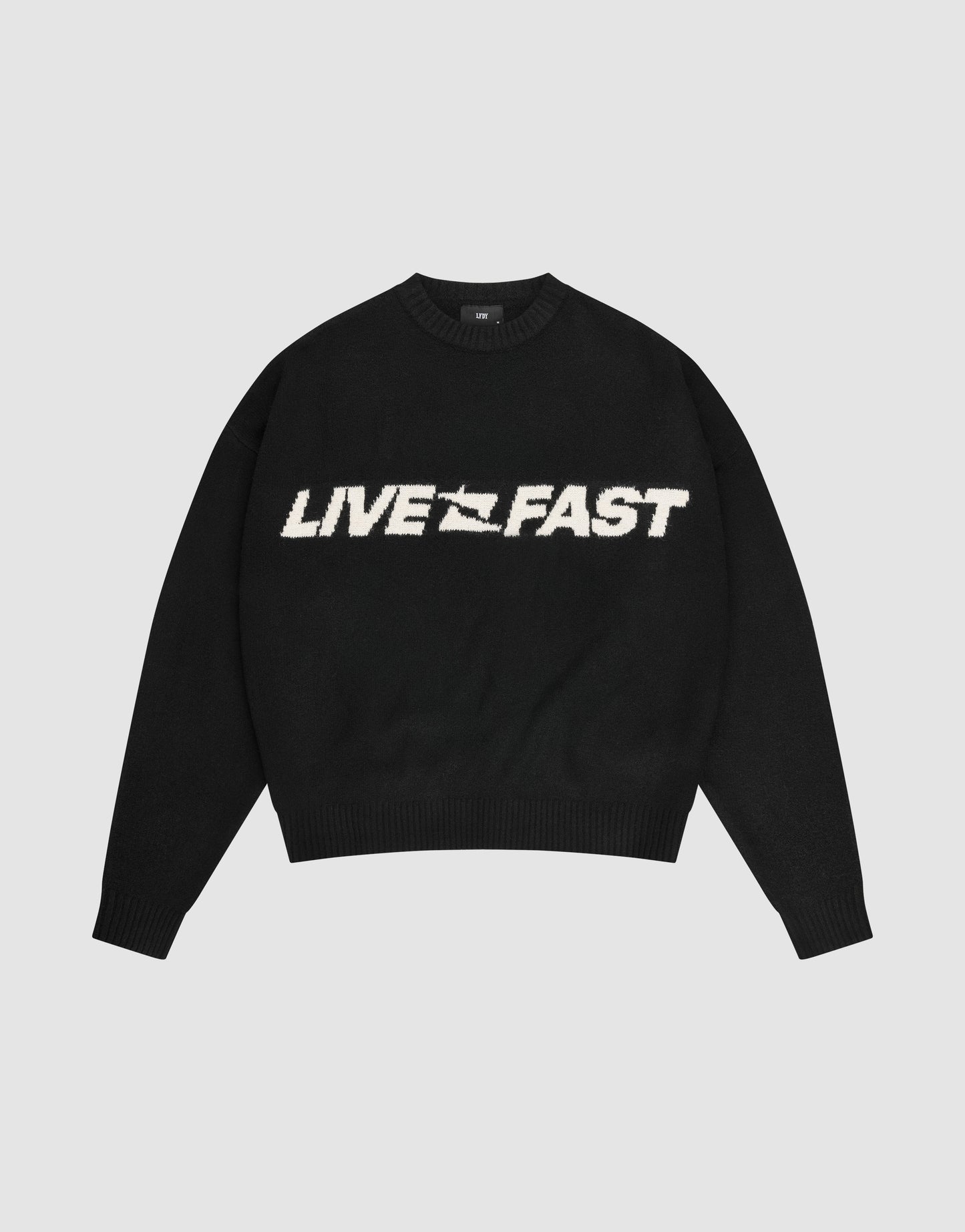The Live Fast Boucle Sweater by LIVE FAST DIE YOUNG is a black oversized crewneck with "LIVE FAST" in bold white lettering across the chest.