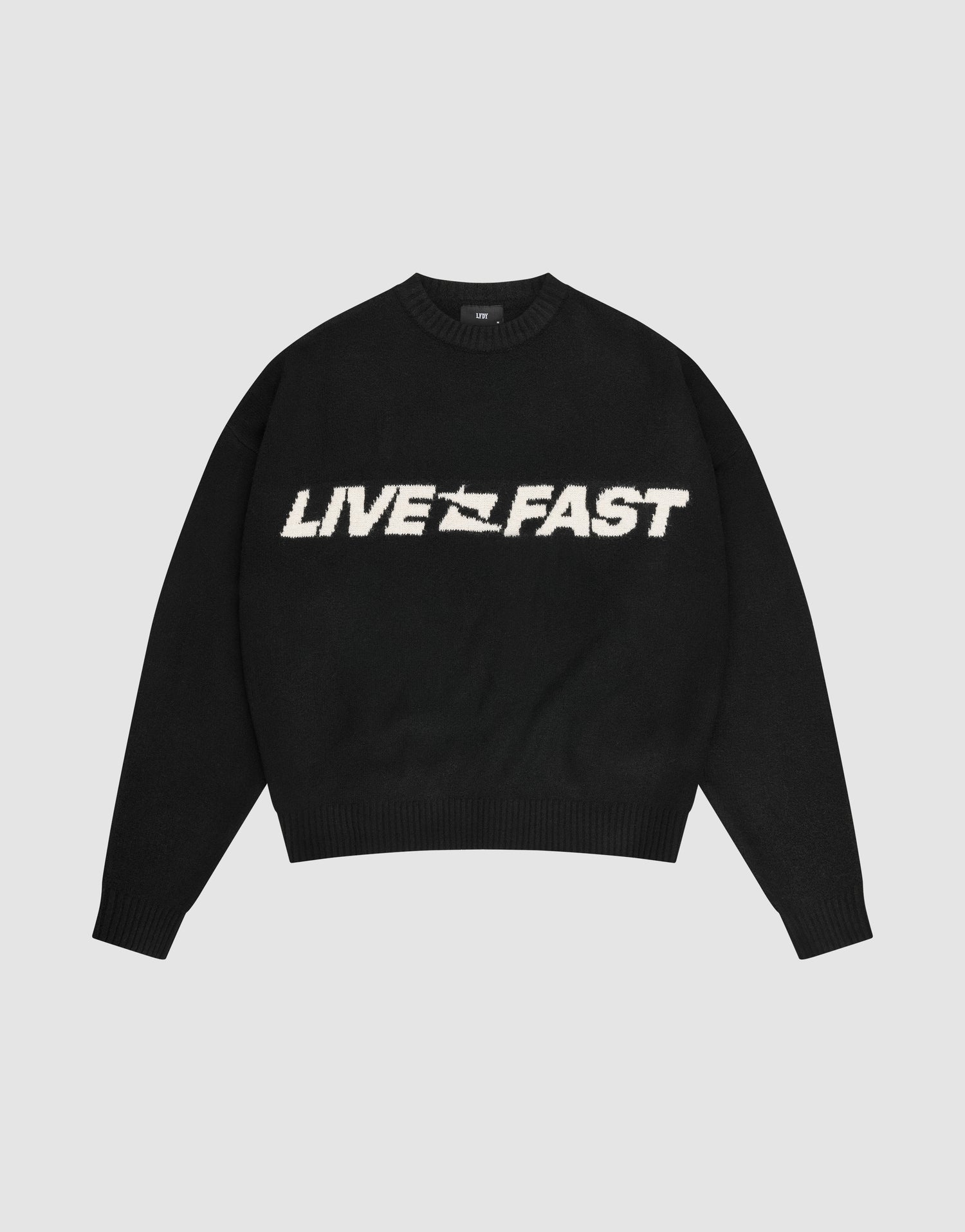 The Live Fast Boucle Sweater by LIVE FAST DIE YOUNG is a black oversized crewneck with "LIVE FAST" in bold white lettering across the chest. | plain
