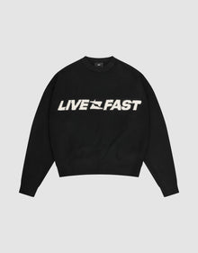 The Live Fast Boucle Sweater by LIVE FAST DIE YOUNG is a black oversized crewneck with "LIVE FAST" in bold white lettering across the chest. | plain