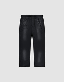 The LIVE FAST DIE YOUNG Live Fast Rhinestone Jogger is a black sweatpant with an elastic waistband and drawstrings, featuring a spray effect gradient and scattered small white dots on the upper front. Shown on a plain light gray background. | plain