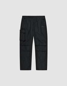 The Live Fast Nylon Pants by LIVE FAST DIE YOUNG feature an elastic waistband, adjustable drawstrings, oversized fit, multiple pockets including a large zip cargo pocket, and a small logo on the left thigh, shown against a light gray background. | plain