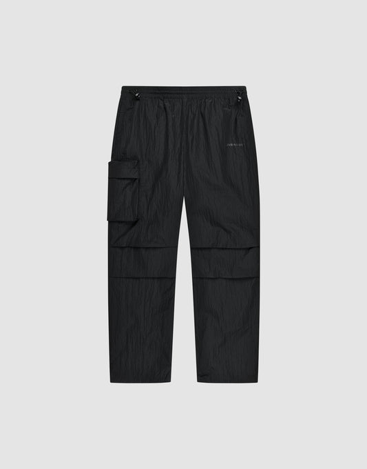 The Live Fast Nylon Pants by LIVE FAST DIE YOUNG feature an elastic waistband, adjustable drawstrings, oversized fit, multiple pockets including a large zip cargo pocket, and a small logo on the left thigh, shown against a light gray background. | plain