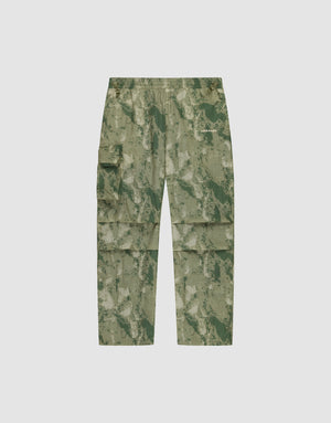 LIVE FAST DIE YOUNG Live Fast Nylon Pants in green camouflage, featuring an oversize fit, multiple cargo pockets, elastic waistband, and zipper, shown flat on a plain light background. | plain